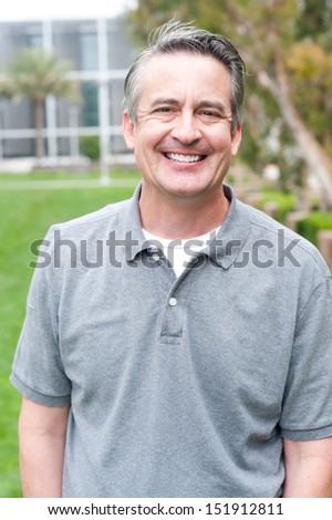 casual portrait of a mature, happy man taken outside