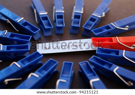 Being different, blue clothespins and one red clothespin