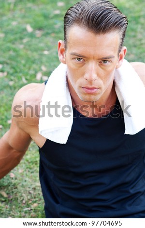Portrait of a young athletic man with workout towel