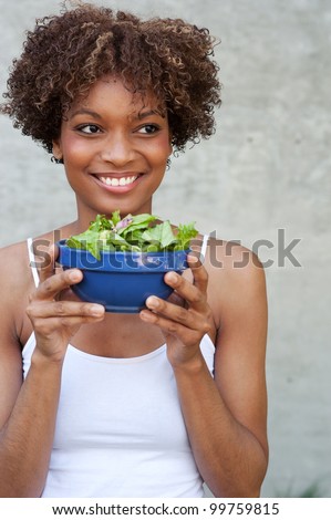 pretty African American woman with a healthy salad