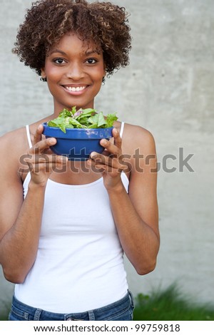 pretty African American woman with a healthy salad