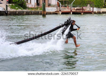 MIAMI,USA FEB 12 2014 - An unidentified man demonstrates fly-board acrobatics while flying on aquaflyer water jetpack at Miami, Florida , USA FEBRUARY 12 2014