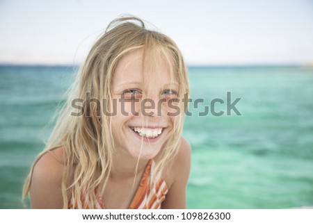 Beautiful blonde girl, natural portrait, laugh by the sea