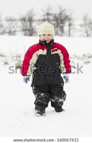 Young kid makes winter fun with sledge outdoor