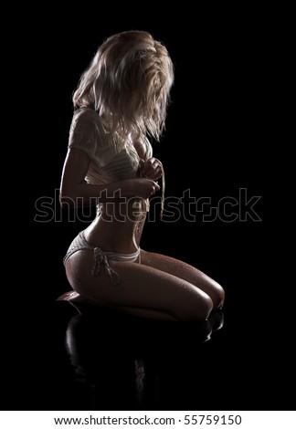 Sexy woman kneel in water, low key