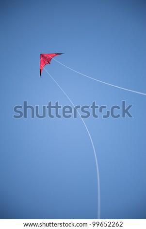 Red kite, blue sky, white strings