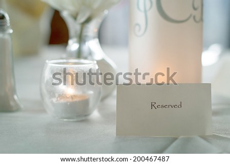 Reserved sign on dinner party table