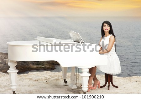 happy beautiful woman resting near sea with grand piano smiling with healthy glossy hair. Rich lady relaxing at beach spring-summer - vacation