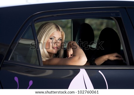 happy young woman in car smiling enjoying car road trip travel vacation. Driving. sexy lady with long blond healthy hair in automobile . spring - summer portrait of tourist girl