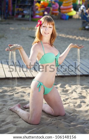 beautiful red hair woman on sand beach. Slim happy girl resting smiling and enjoying summer sun. Romantic lady in swimwear having fun at vacation holidays. Alluring bikini model at exotic spa resort