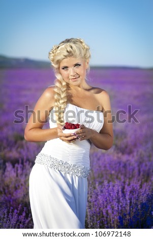 beautiful slim bride in luxury wedding dress in purple lavender flowers. Fashion romantic happy woman with blond hair. Smiling girl resting on sunset in summer lavender field waiting for groom.Series