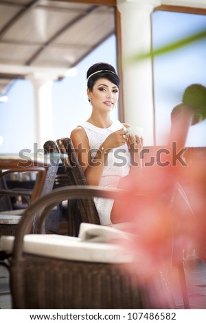 vintage beautiful woman in restaurant cafe cup of coffee.Healthy drink for breakfast.Stylish rich slim girl in retro dress. glamorous romantic lady at vacation. Woman on date.Retro style.France.series