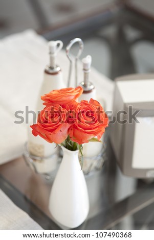 fresh roses in vase on table in restaurant in the morning. stylish decoration. happy lifestyle vacation and holiday concept. flowers - tables set for fine dining. wedding decore