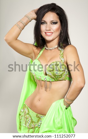 beautiful slim girl bellydancer sexy arabian turkish oriental professional artist in carnival shining costume with long glossy hair. alluring woman dancing erotic dance. exotic star of bellydance