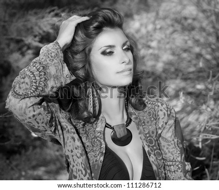 alluring beautiful woman in oriental shirt posing outdoor. Sexy romantic girl with hand made beads relaxing at nature. Fashion model with professional makeup. Summer-autumn