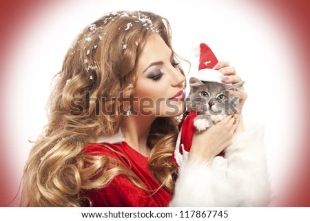 Beautiful christmas woman in Santa Clause costume with extra long curly hair. winter portrait of sexy santa girl with copy space. attractive new year and xmas party lady, isolated on white background