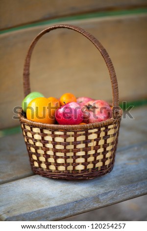 Healthy Organic Apples in the Basket on wooden floor. Fresh and colorful fruits in basket from country harvest, selective focus. Jonagold apples. health and diet food concept. Tonality added