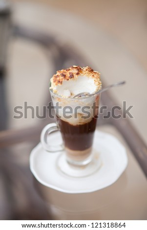 Cappuccino or latte coffee. fresh tasty cocoa cocktail in restaurant for dinner. Frothy, layered cappuccino in glass mug with vanilla cookies cinnamon sprinkled on top. italian creamy Latte in cafe