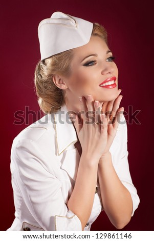 Beautiful blonde woman stewardess or sailor in marine concept and