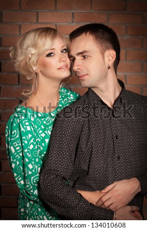 Happy couple in love having fun in studio. Loving couple embracing. Beautiful woman and man posing in casual summer clothes. Relationship/ Boyfriend and girlfriend on dating.