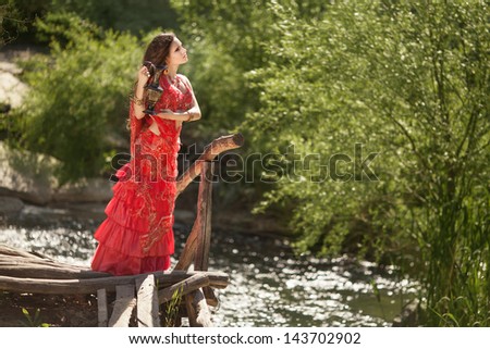 Beautiful young indian woman in traditional clothing with bridal makeup and jewelry. gorgeous brunette bride traditionally dressed Outdoors in India. Girl bollywood dancer in Sari. Arabian bellydancer