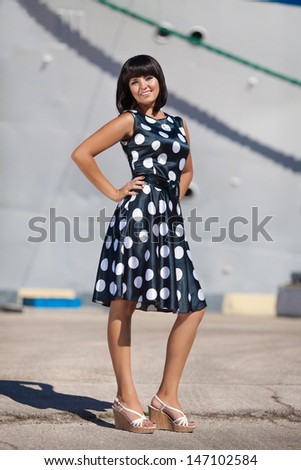 Beautiful Vacation Woman in dock at big cruise ship happy summer woman smiling at sea trip. Happy travel woman sexy girl in summer dress. Sea vacation girl. Resting woman at cruise liner. tourist girl