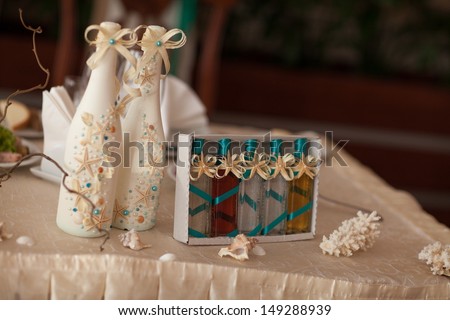 Wedding champagne decoration with seashells starfish at royal wedding diinner. Wedding table decoration at tropical bridal table. thailand wedding. alcoholic drink decorated sea style. wedding decor