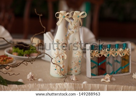 Wedding champagne decoration with seashells starfish at royal wedding dinner. Wedding table decoration at tropical bridal table. thailand wedding. alcoholic drink decorated sea style. wedding decor