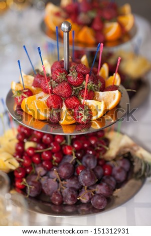 fruits strawberry and champagne on wedding table, wedding party dinner. Fresh summer fruit on table in cafe restaurant. Tasty healthy food for dinner. Thailand. Maldives.