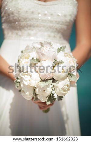 bride with wedding bouquet  peony flowers. Bridal flowers at wedding day. beautiful bouquet of marriage flowers. wedding decoration.beige and white wedding flowers. peony bouquet at summer wedding