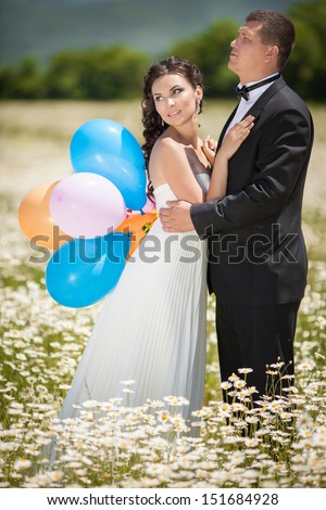 Bride and groom at wedding day. Happy newlywed couple dancing at marriage ceremony. Smiling bride and groom. Beautiful couple in love at honeymoon. Man and woman embracing bride and groom.
