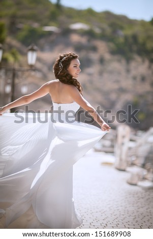 Beautiful bride at wedding dress walking outdoors. Newlywed woman. Bride at marriage. Woman in wedding dress near sea. bride dance at wedding day. Girl in bridal dress on nature. happy wedding. series