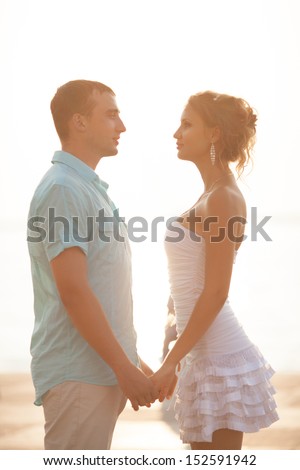 Beautiful Young Couple  man and woman in love. Teenage couple embracing on dating. Hugging couple. Smiling man and woman embracing.  happy loving couple on dating. Young couple in love outdoor.