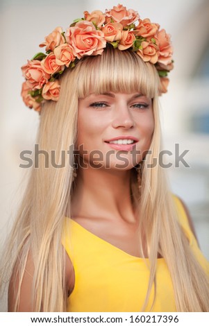 Beautiful autumn woman with flower wreath smiling outdoors. Happy healthy woman portrait . Cosmetology. Perfect beauty smilinggirl. elegant woman in spring park.