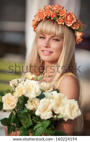 Attractive smiling woman with flowers wreath outdoors. Healthy woman natural beauty. Cosmetology and heath care. Happy beautiful teenager girl at street.
