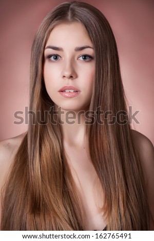 Beautiful woman with long healthy hair and perfect clean skin studio portrait. beauty model with natural makeup. Hairstyle. Skin care. long glossy brunette hair.