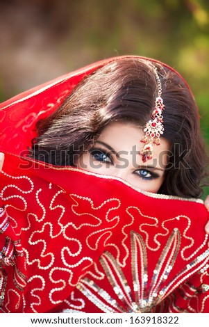 Beautiful Indian woman portrait, bright makeup woman with golden jewelry. Gorgeous Indian girl eyes. Indian beauty. Beautiful native Indian lady