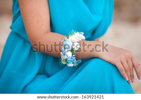 Fashion hand made blacelet on woman hand with seashells and perls. Female decoration