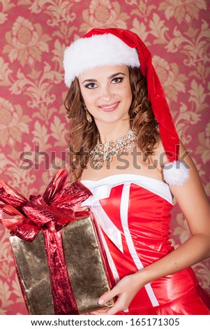 Christmas woman, new year concept, happy girl in santa claus hat, smiling girl with new year gift, winter concept. Santa helper elf with xmas gift at new year tree. winter concept.