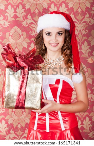 Christmas woman, new year concept, happy girl in santa claus hat, smiling girl with new year gift, winter concept. Santa helper elf with xmas gift at new year tree. winter concept.