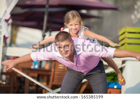 Happy family outdoors, father and daughter having fun. Man and little girl beautiful family. Father playing with daughter baby girl.