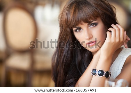 Alone woman in cafe, sad beautiful girl. Attractive bored woman in restaurant. Beautiful young woman dining at restaurant.