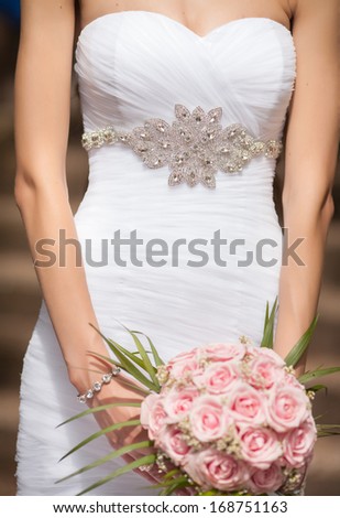 wedding bouquet at bride hands. wedding flowers pink roses, newlywed woman with bouquet.
