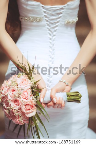 wedding bouquet at bride hands. wedding flowers pink roses, newlywed woman with bouquet.