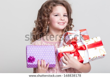 Cute little girl with birthday gift box. Happy child with gifts. Glamour baby girl hold presents.