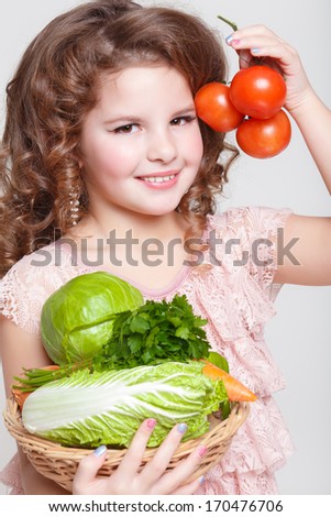 Cute Child with vegetables, Gardening. Lovely little girl with basket of ecological harvests, Kid with healthy food. studio, isolated on white background.