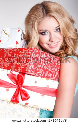 Happy young woman with gift boxes, birthday or Valentines Day party. Beautiful smiling girl with gift. Shopping sales.Joyful woman with presents. Isolated, studio, white background.