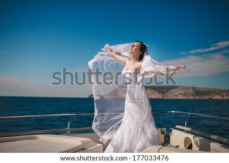 Beautiful Bride at Wedding day at luxury yacht at sea, happy newlywed woman outdoors in wedding dress and veil. Marriage day emotional moments. Series.