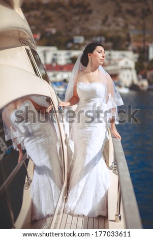 Beautiful Bride at Wedding day at luxury yacht at sea, happy newlywed woman outdoors in wedding dress and veil. Marriage day emotional moments. Series.