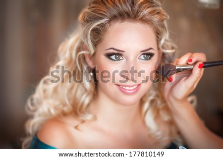 Beautiful bride with wedding makeup and hairstyle, attractive newlywed woman have final preparation for wedding. Bride waiting groom. Happy newlywed. Marriage. Wedding day moments. Bride makeup.